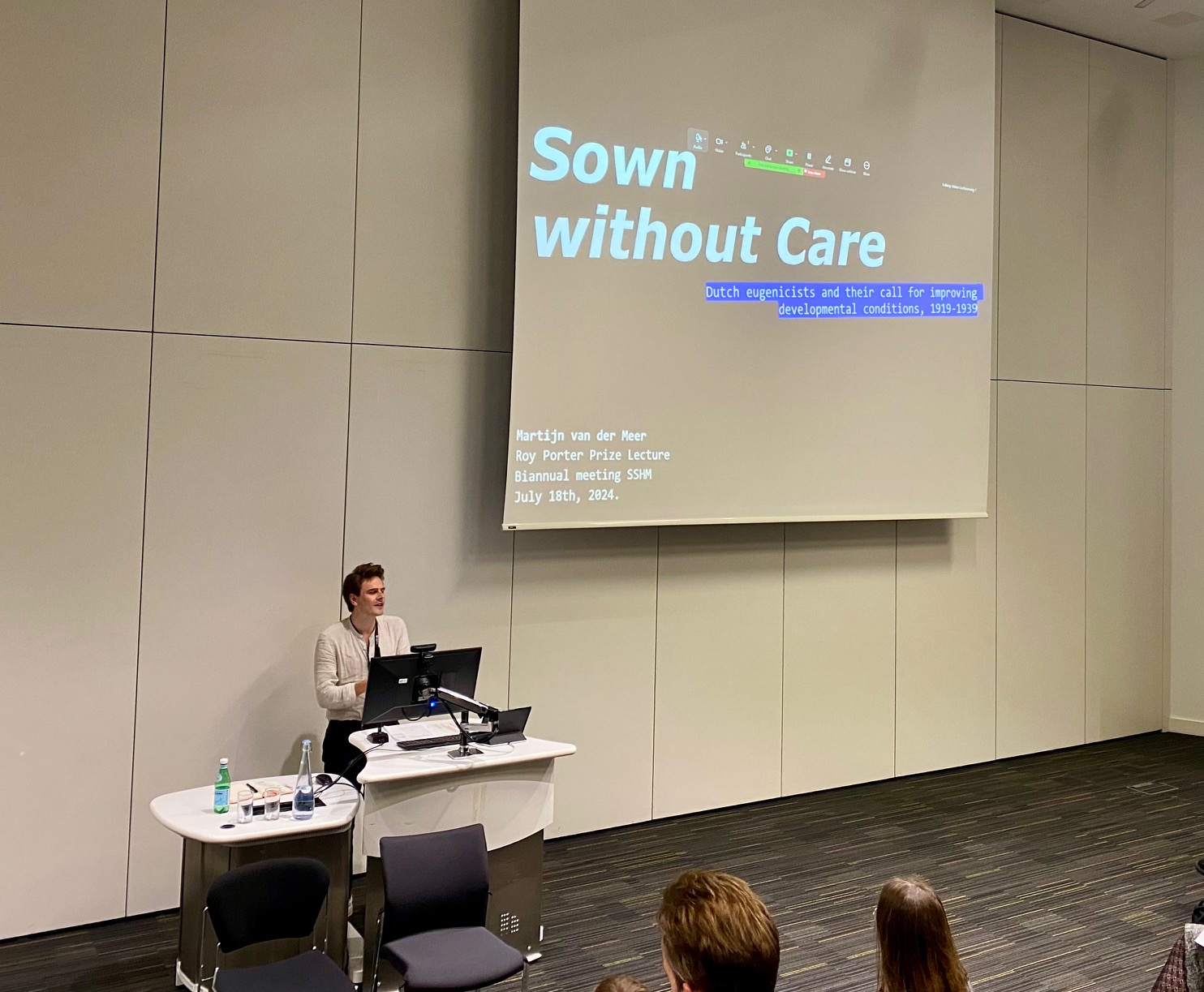 Photo showing man at lectern delivering a lecture